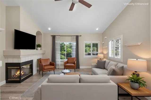 a living room with furniture a fireplace and a flat screen tv