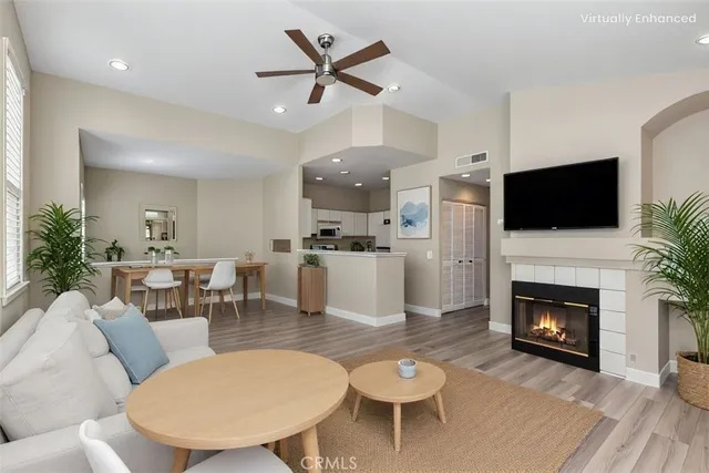 a living room with furniture a fireplace and a flat screen tv