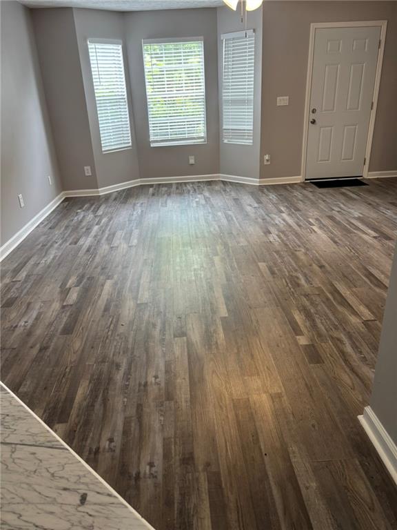 5739 Windfall Lane Lithonia, GA 30058 - Photo 7 of 36 an empty room with wooden floor and windows