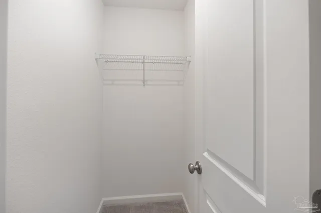 a kitchen with kitchen island white cabinets and refrigerator