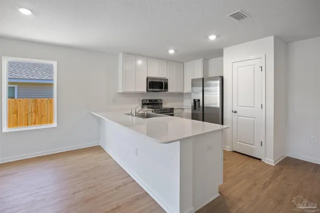 a kitchen with a sink and cabinets