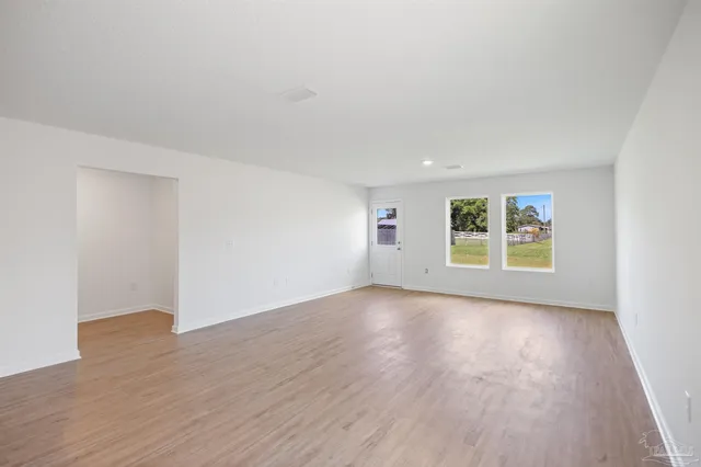 a view of a kitchen with a sink and wooden floor
