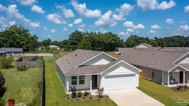 an aerial view of a house with a swimming pool