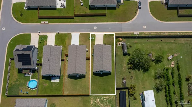 an aerial view of residential houses with outdoor space