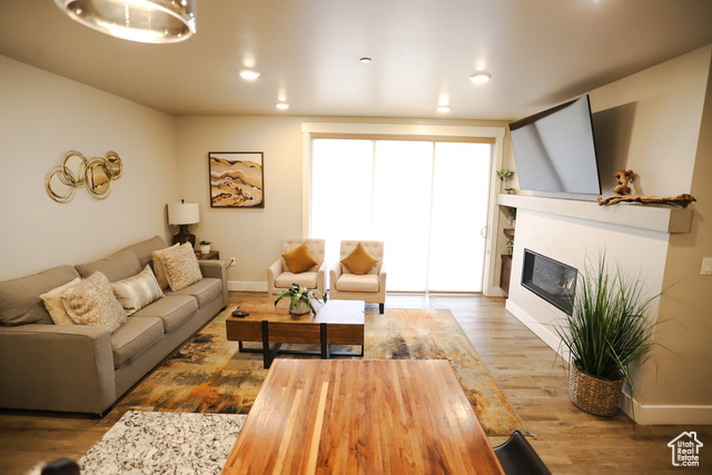 2331 Mesa Road, Unit E3 Moab, UT 84532 - Photo 15 of 71 Living room with wood finished floors, a glass covered fireplace, and recessed lighting