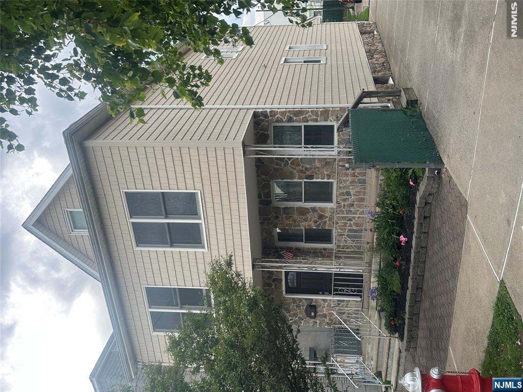 159 Division Avenue, Unit 2 Garfield, NJ 07026 - Photo 1 of 14 a front view of a house with a yard