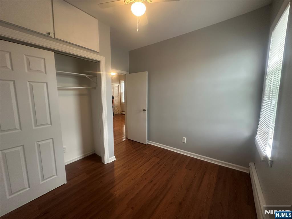 159 Division Avenue, Unit 2 Garfield, NJ 07026 - Photo 11 of 14 a view of an empty room with wooden floor and a window