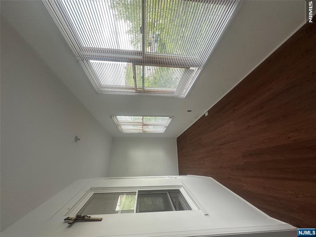 159 Division Avenue, Unit 2 Garfield, NJ 07026 - Photo 12 of 14 a view of an empty room with wooden floor and a window
