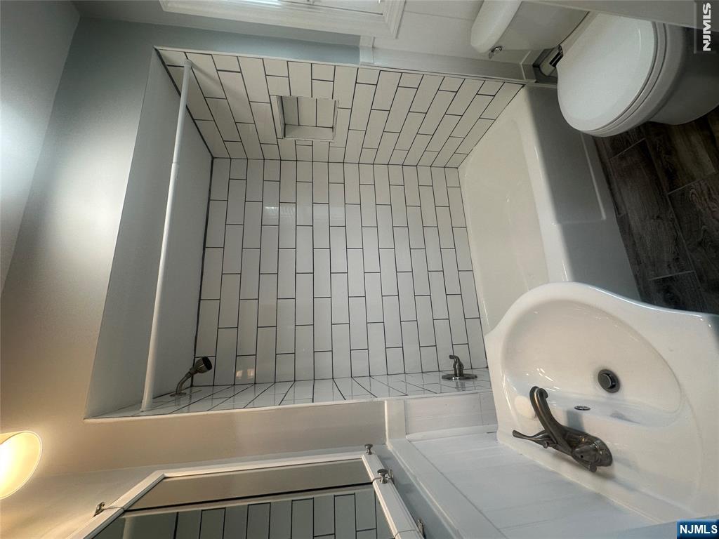 159 Division Avenue, Unit 2 Garfield, NJ 07026 - Photo 13 of 14 a bathroom with a sink and a toilet