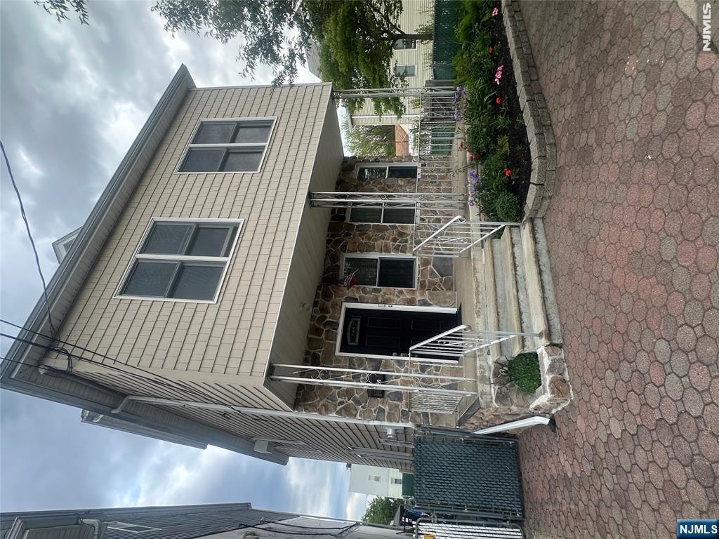 159 Division Avenue, Unit 2 Garfield, NJ 07026 - Photo 2 of 14 a front view of a house with entryway