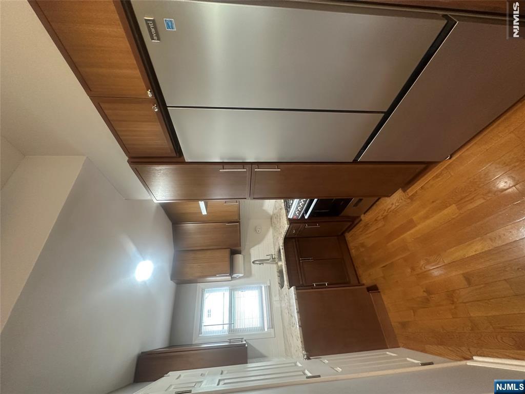 159 Division Avenue, Unit 2 Garfield, NJ 07026 - Photo 4 of 14 a kitchen with stainless steel appliances granite countertop a refrigerator and a sink