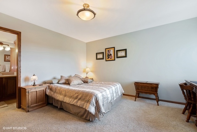 3812 Redwood Court Spring Grove, IL 60071 - Photo 24 of 37 a bedroom with two beds and a lamp