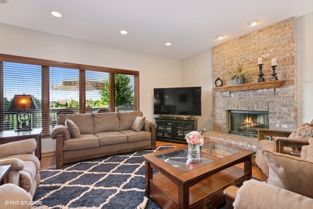 3812 Redwood Court Spring Grove, IL 60071 - Photo 5 of 37 a living room with furniture a fireplace and a flat screen tv