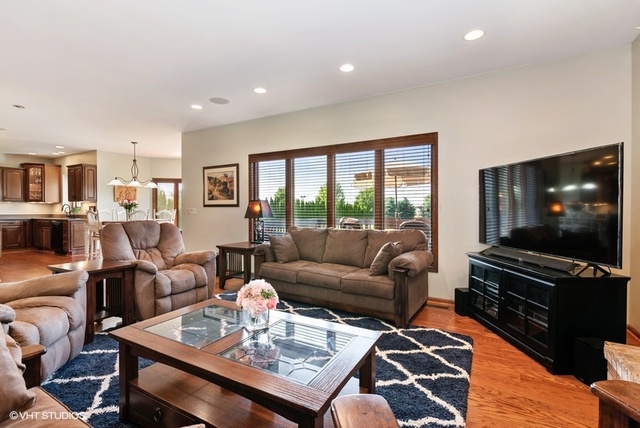 3812 Redwood Court Spring Grove, IL 60071 - Photo 6 of 37 a living room with furniture and a flat screen tv