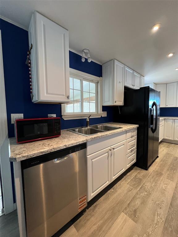 6528 Roosevelt Drive Port Richey, FL 34668 - Photo 11 of 42 a kitchen with stainless steel appliances granite countertop a sink a stove a refrigerator a microwave and cabinets