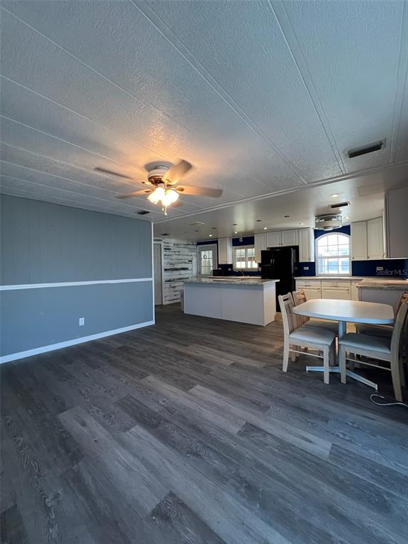 6528 Roosevelt Drive Port Richey, FL 34668 - Photo 16 of 42 a living room with furniture and a kitchen view