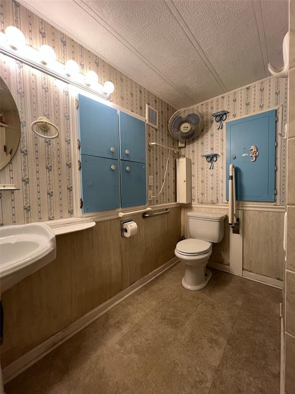 6528 Roosevelt Drive Port Richey, FL 34668 - Photo 18 of 42 a bathroom with a sink mirror and toilet