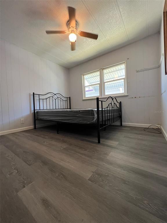 6528 Roosevelt Drive Port Richey, FL 34668 - Photo 21 of 42 a view of a bedroom with furniture window and a ceiling fan