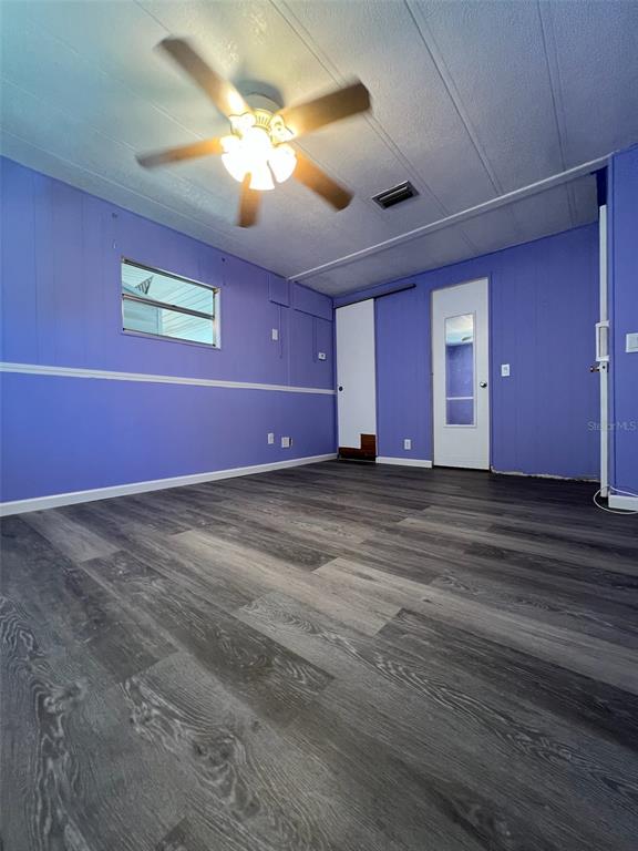 6528 Roosevelt Drive Port Richey, FL 34668 - Photo 24 of 42 a view of an empty room with window and chandelier fan