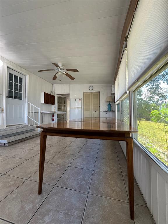 6528 Roosevelt Drive Port Richey, FL 34668 - Photo 32 of 42 a view of a living room with furniture and a floor to ceiling window