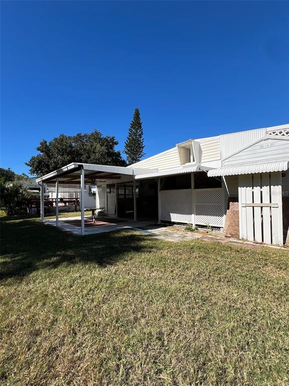 6528 Roosevelt Drive Port Richey, FL 34668 - Photo 41 of 42 a front view of a house with a garden