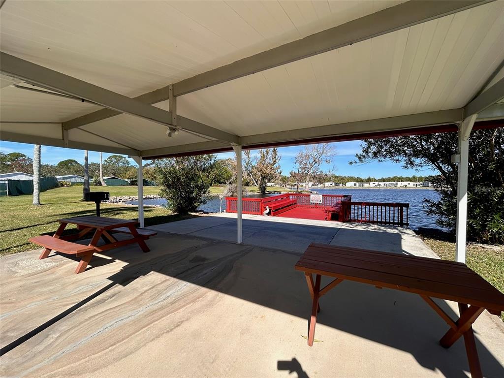 6528 Roosevelt Drive Port Richey, FL 34668 - Photo 7 of 42 a living room with patio furniture and a garden view