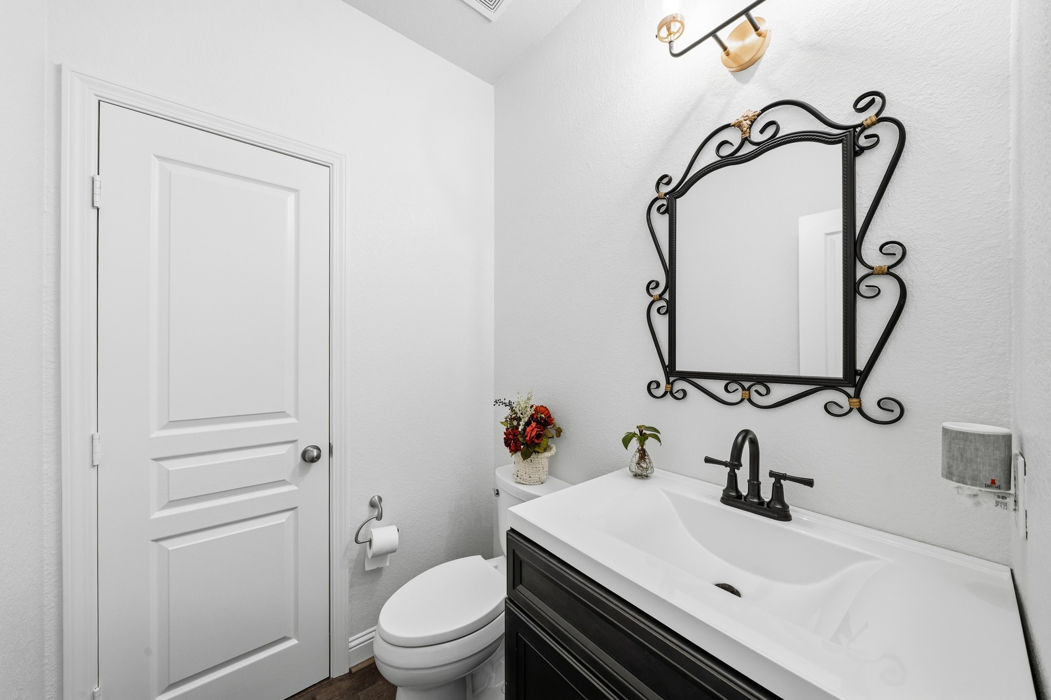 17610 Strackfield Lane Tomball, TX 77377 - Photo 20 of 50 Designer finishes elevate this stylish powder room, where a furniture-style vanity, statement mirror, and curated lighting create a sophisticated guest experience.