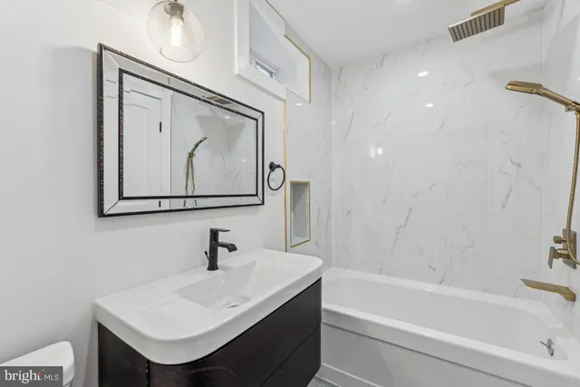 a bathroom with a sink a mirror and a bathtub