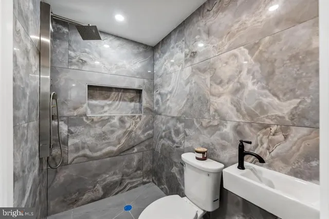 a kitchen with stainless steel appliances a sink a stove and cabinets