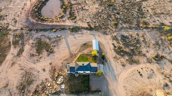a kitchen with stainless steel appliances granite countertop a sink a stove top oven a counter space and cabinets