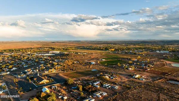 a view of a hallway with wooden floor and entryway