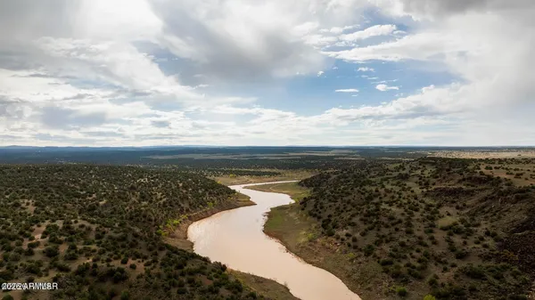 a bathroom with a double vanity sink a mirror and a bathtub
