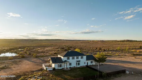 a view of a pathway with a wrought fence