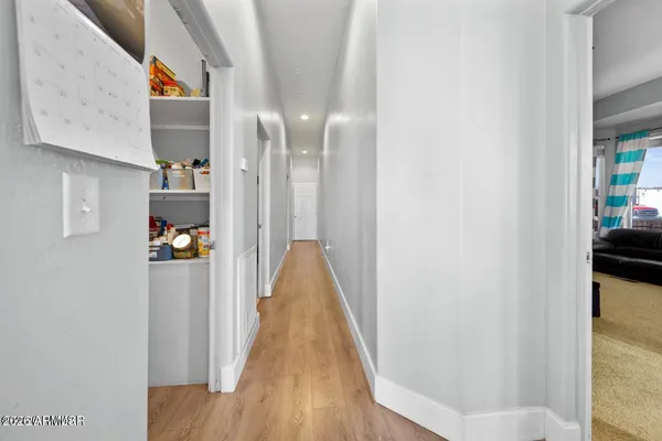 a kitchen with a refrigerator and white cabinets