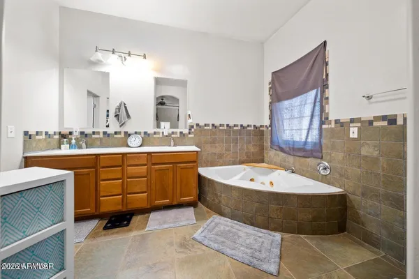 a bathroom with a granite countertop sink a toilet and shower