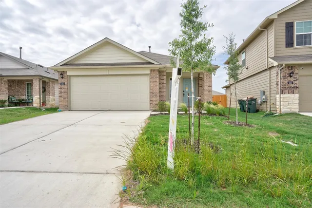 a front view of a house with yard
