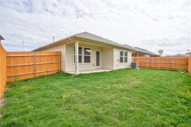 a backyard of a house with yard and barbeque oven