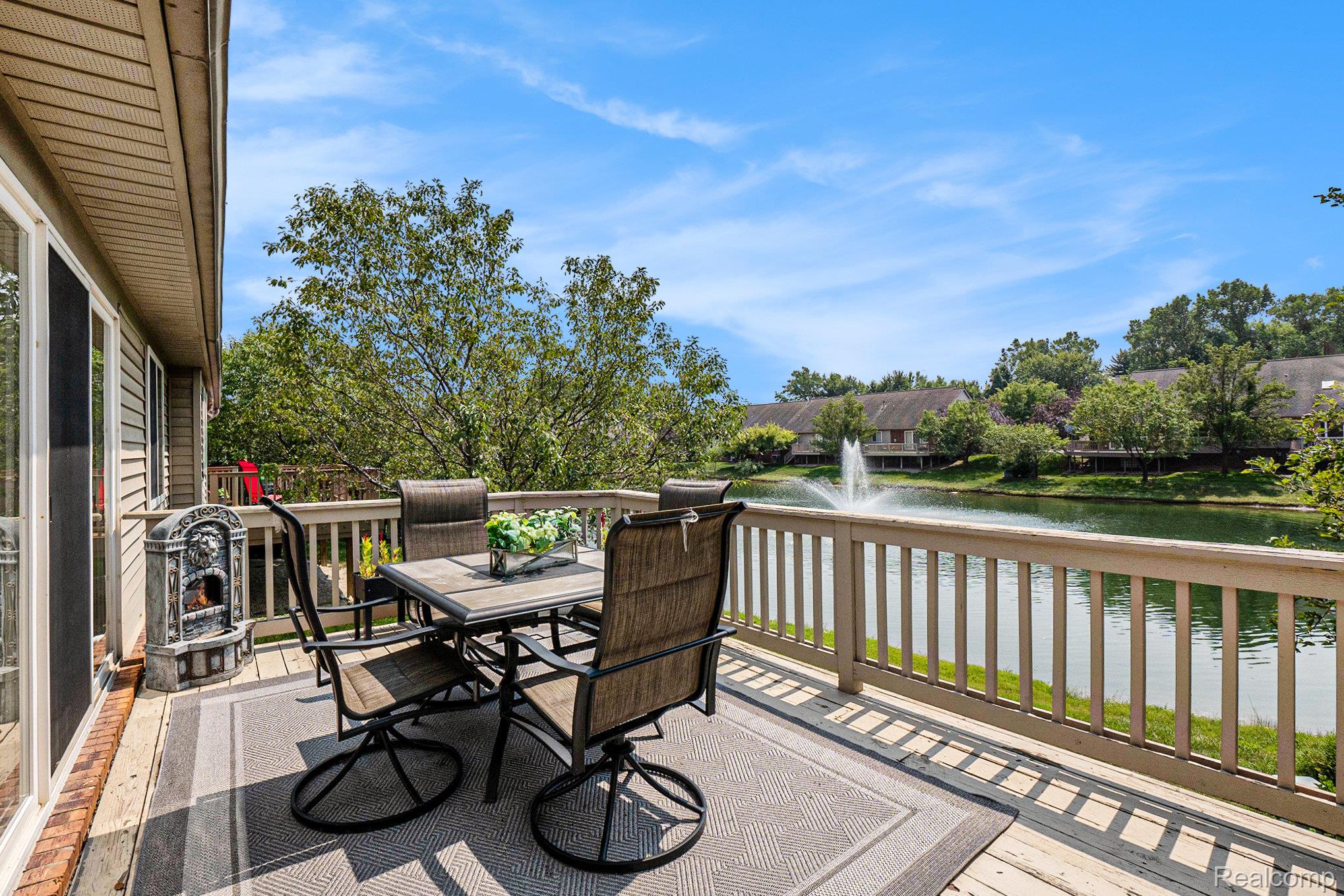 5477 Victory Circle Sterling Heights, MI 48310 - Photo 29 of 32 Spacious outdoor deck featuring light-toned wood railing and a backdrop of mature trees