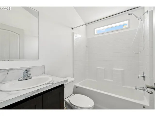 a row of trees with wooden fence