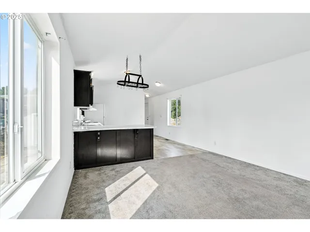 a spacious bathroom with a tub sink and mirror