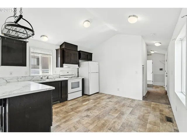 a kitchen with a sink appliances and cabinets
