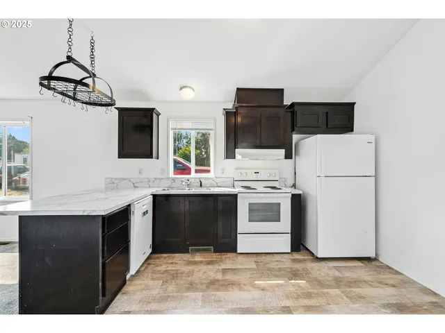 a kitchen with a sink cabinets and appliances