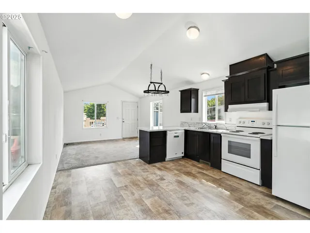 a kitchen with stainless steel appliances a sink stove and refrigerator