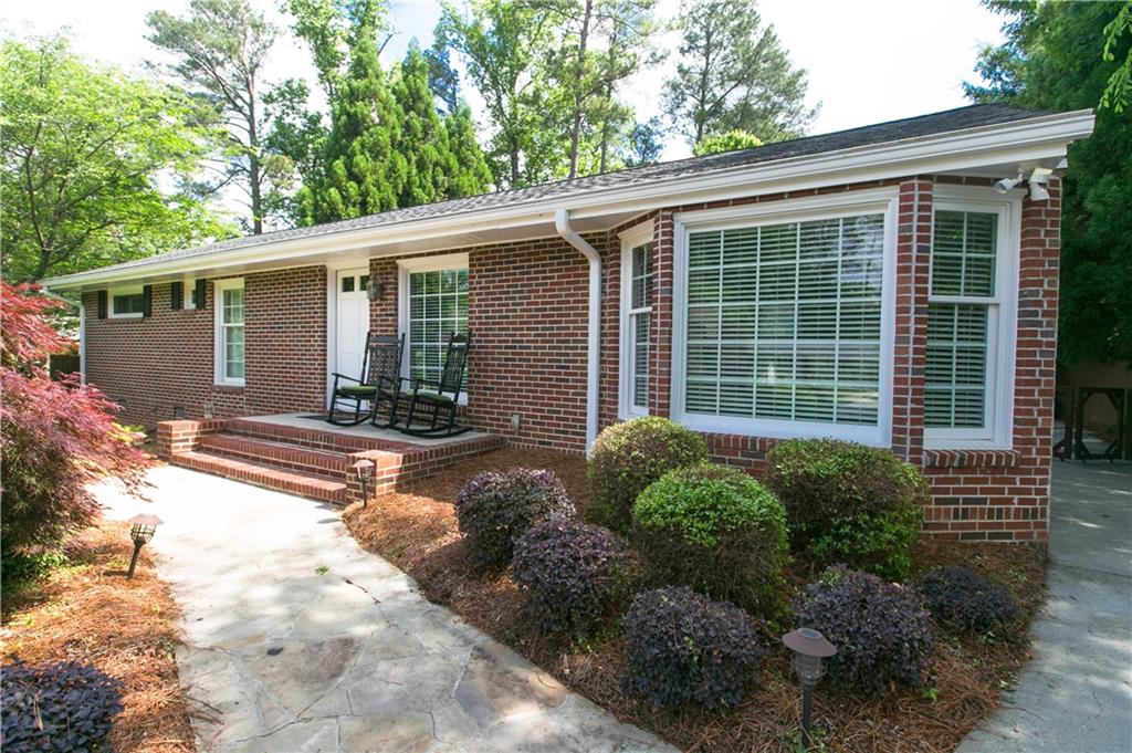 2701 Ashford Road Northeast Brookhaven, GA 30319 - Photo 1 of 1 a front view of a house with garden