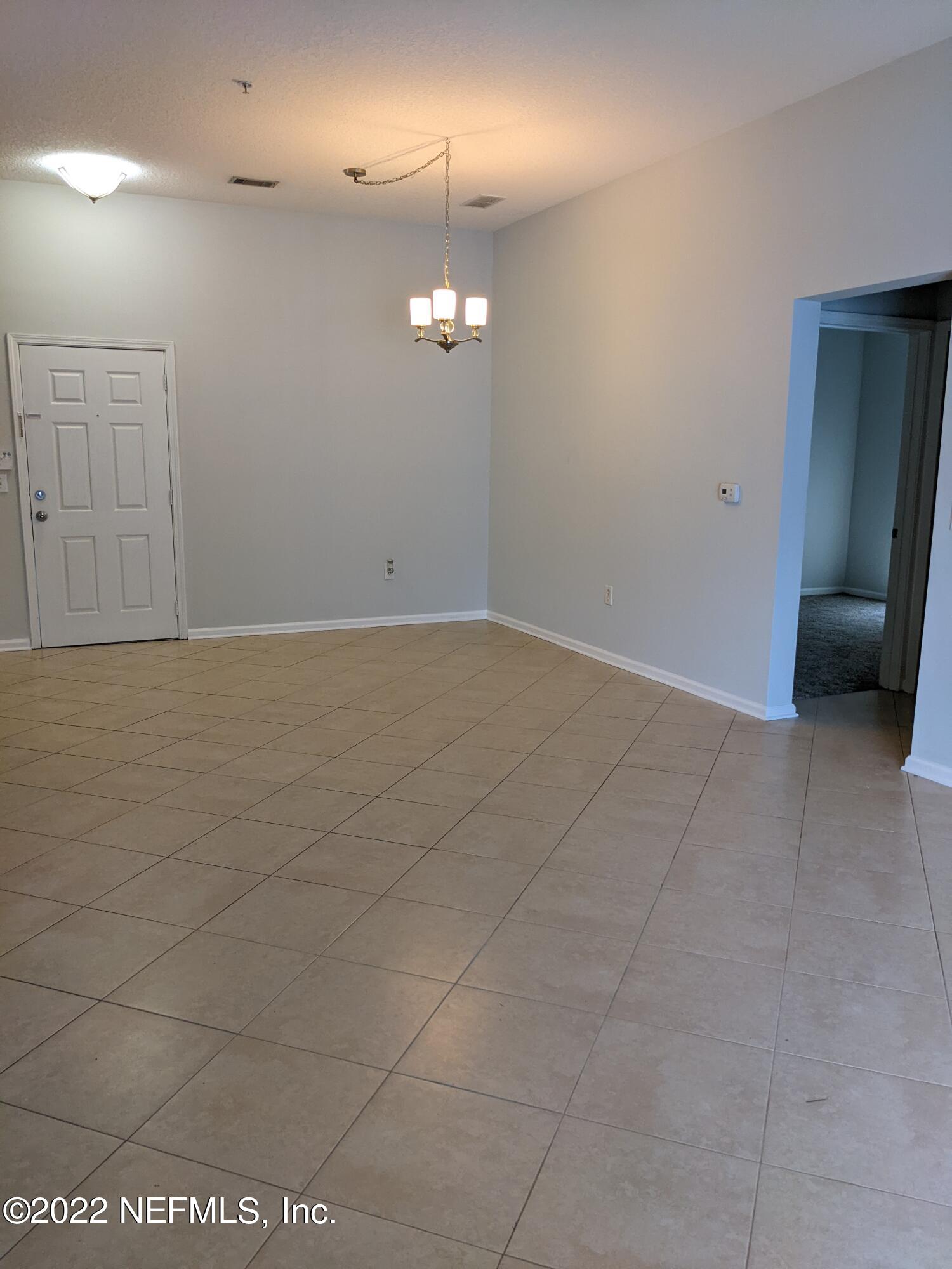 7920 Merrill Road, Unit 1001 Jacksonville, FL 32277 - Photo 4 of 21 a view of an empty room with a window