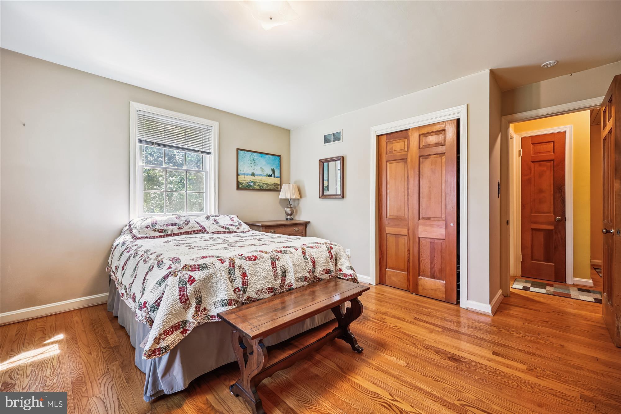 111 Ednor Road Silver Spring, MD 20905 - Photo 23 of 36 a bedroom with a bed and wooden floor