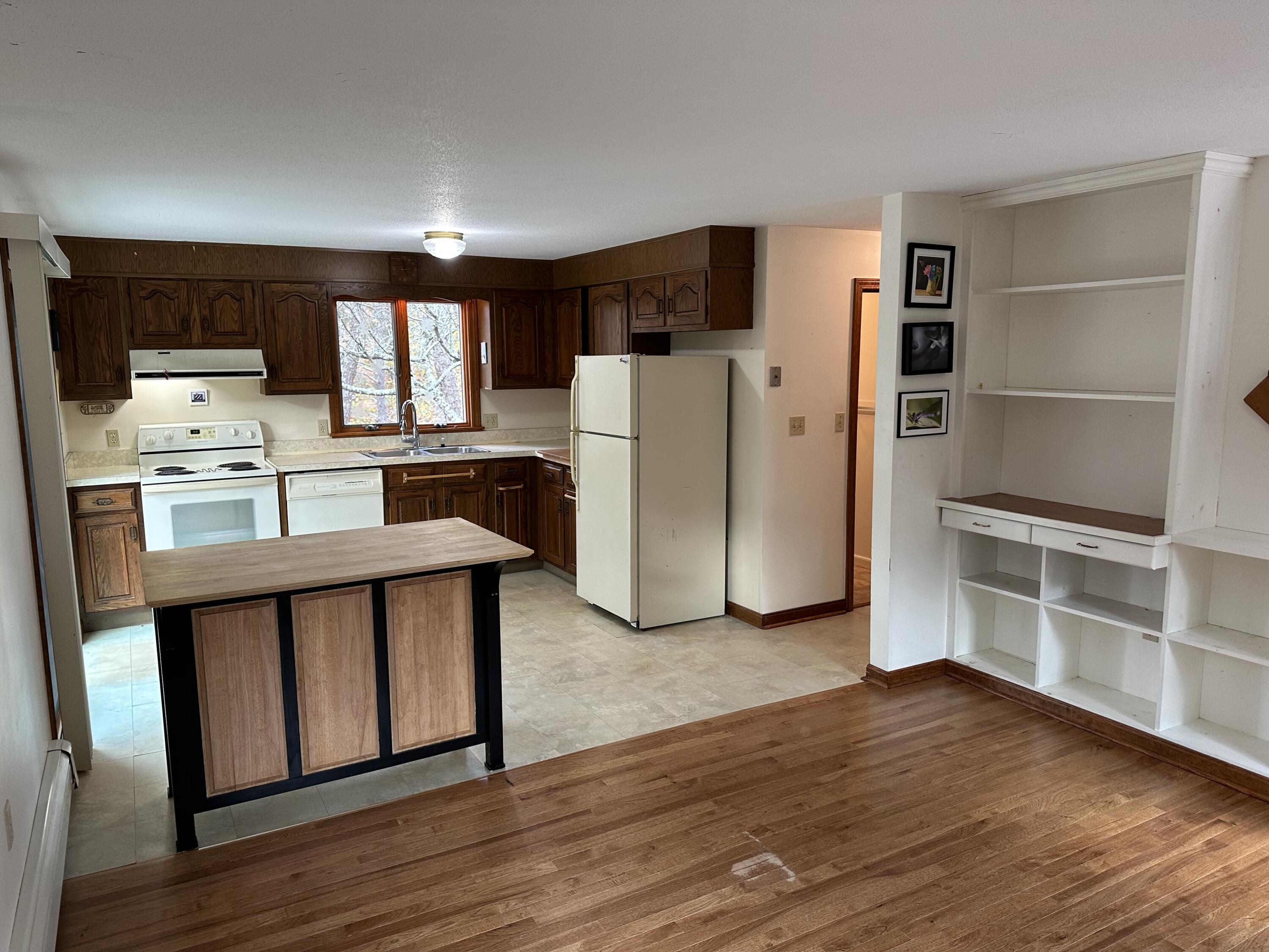 16 Warren Road Wellfleet, MA 02667 - Photo 12 of 24 a kitchen with refrigerator cabinets and wooden floor