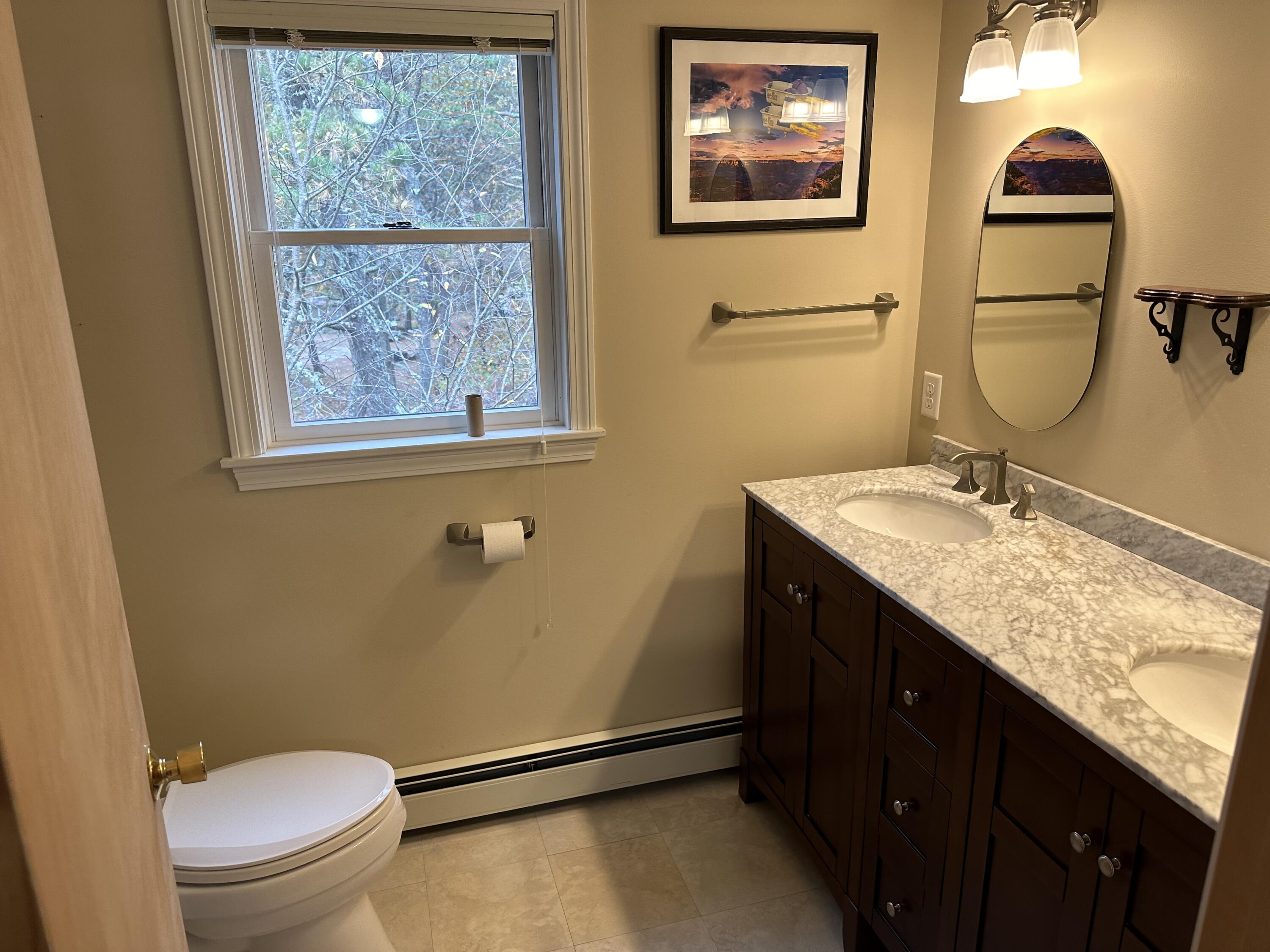 16 Warren Road Wellfleet, MA 02667 - Photo 21 of 24 a bathroom with a granite countertop toilet sink and mirror