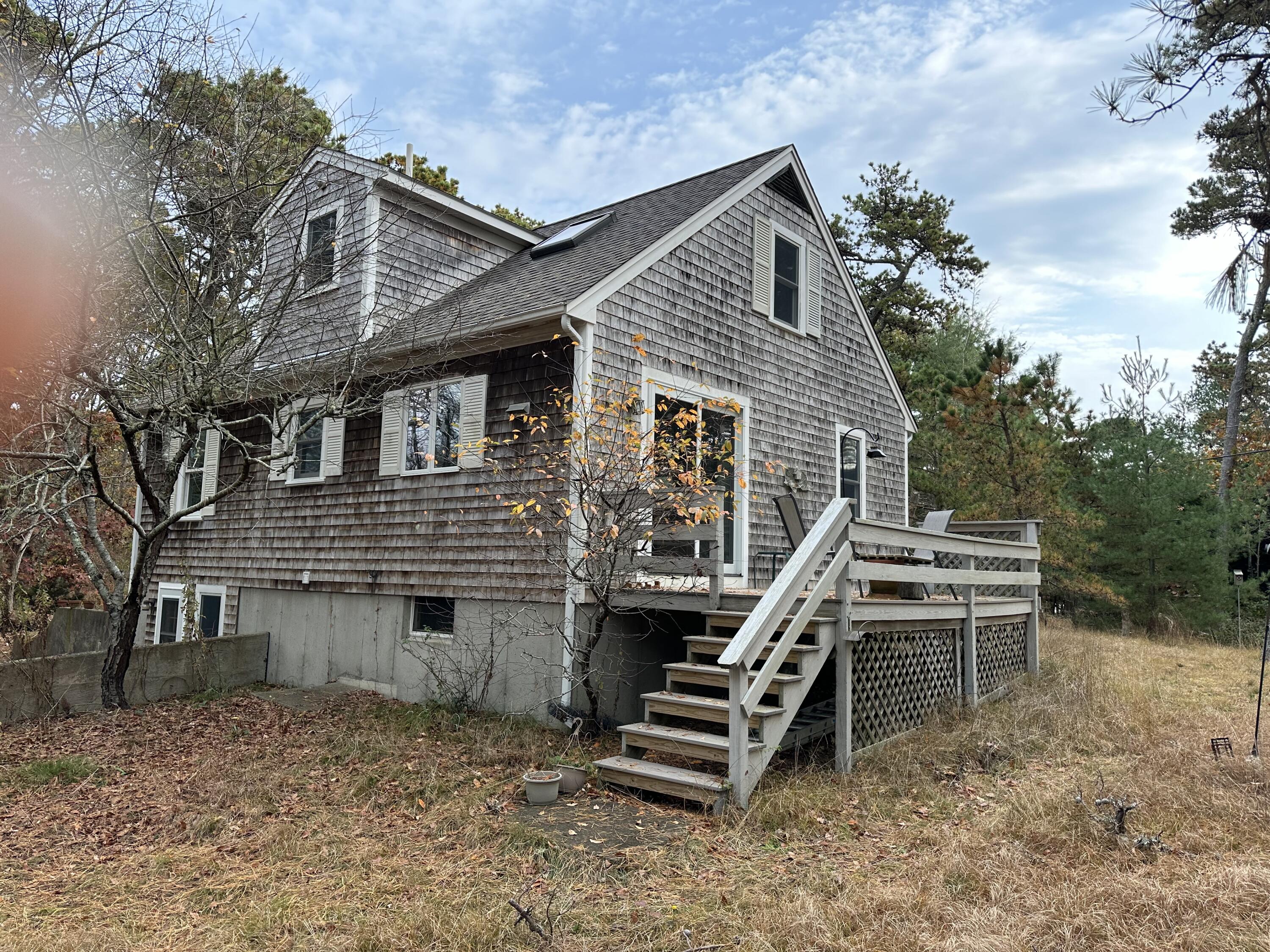 16 Warren Road Wellfleet, MA 02667 - Photo 3 of 24 a front view of a house with a yard