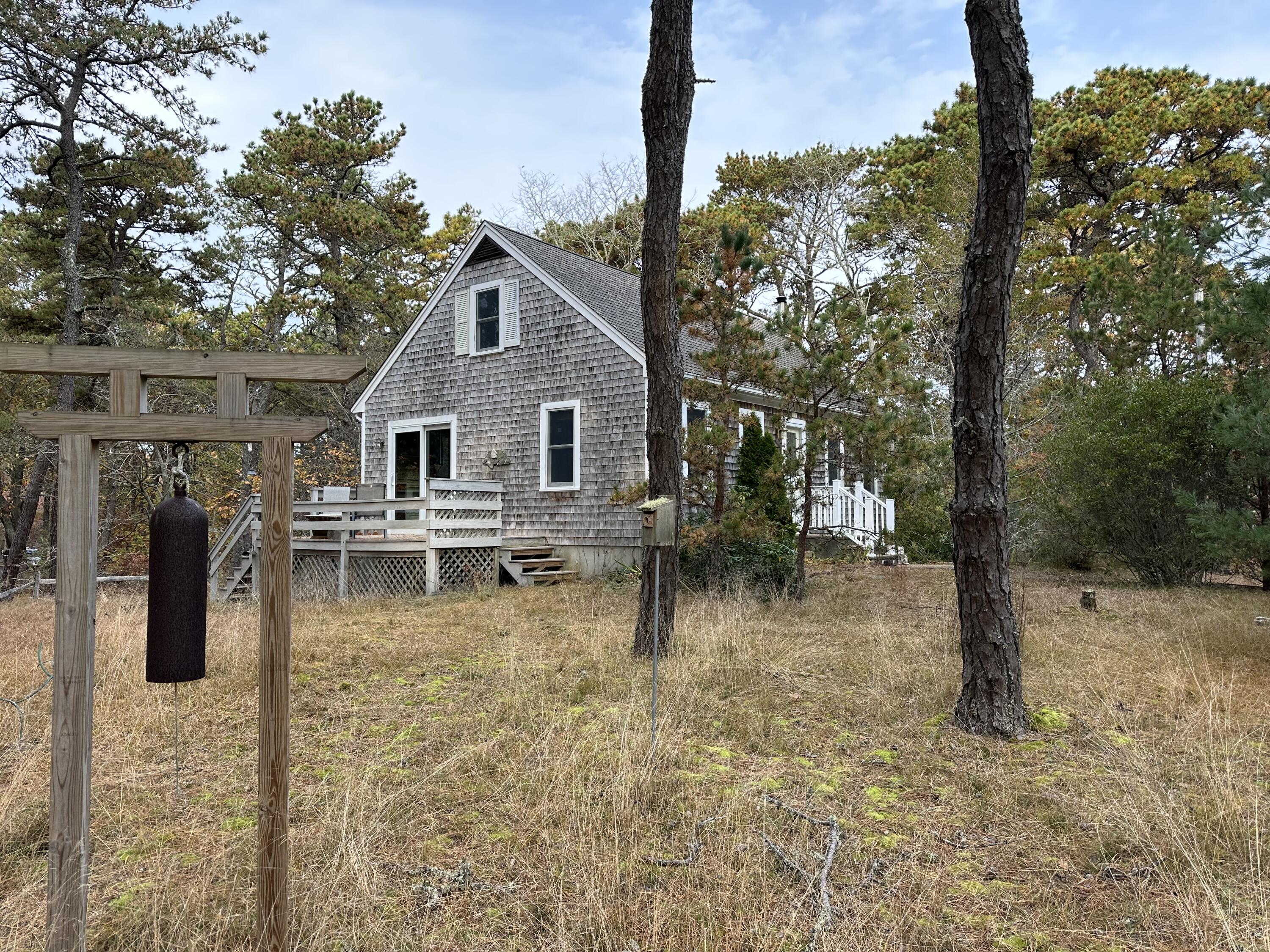 16 Warren Road Wellfleet, MA 02667 - Photo 7 of 24 a backyard of a house with barbeque oven and outdoor seating